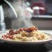 A close-up of steaming rice with beans, captured in warm afternoon light.