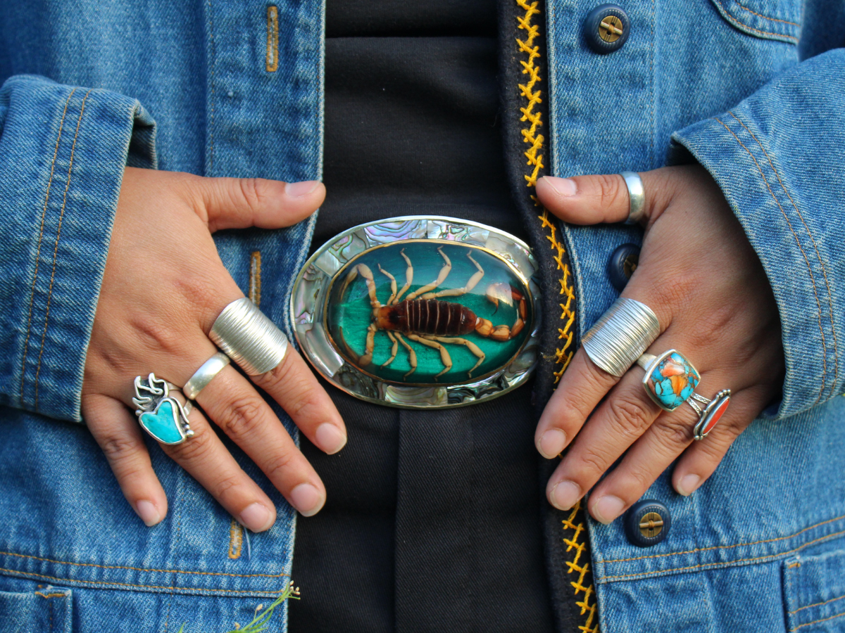 woman wearing turquoise buckle, scorpion belt buckle, the scorpio woman