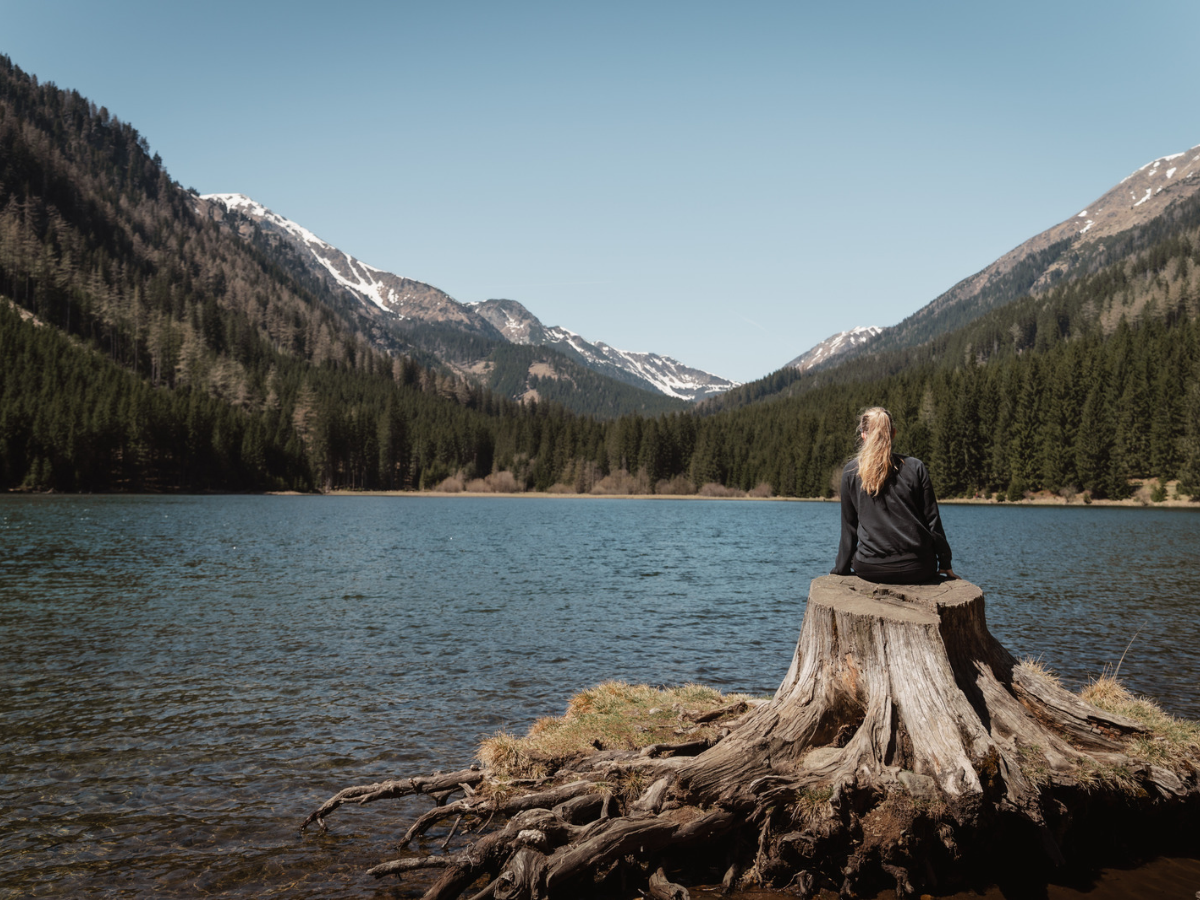 woman watching the water, view of woman sitting at the shore, the Taurus woman