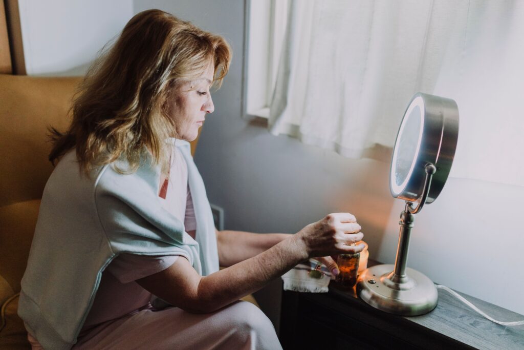 A woman enjoying a calming beauty routine in a serene indoor setting, enhancing wellness.